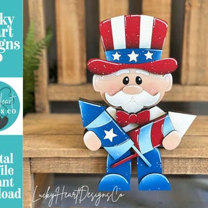 May include: A wooden Uncle Sam figure with a red, white, and blue color scheme. The figure wears a top hat and holds two firework rockets. The image includes the text "Lucky Heart Designs Co" and "Digital cut file instant download".