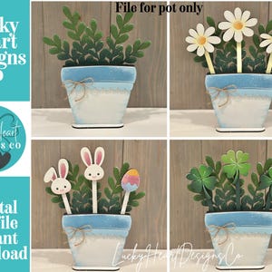 May include: A collection of wooden decorative pots with various designs. Each pot is white with a blue rim and a twine bow. The pots feature different plant and flower arrangements, including daisies, clovers, and Easter-themed elements. The text "Lucky Heart Designs Co" and "Digital cut file instant download" are visible.