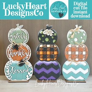 May include: Three stacked pumpkin decorations made of layered wood. The left stack features the words grateful, thankful, and blessed. The middle stack has polka dots, plaid, and chevron patterns. The right stack shows polka dots, plaid, and chevron.