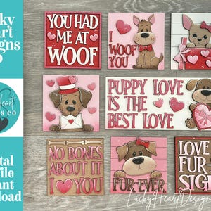 May include: A collection of square wooden signs with dog-themed phrases and illustrations. The signs feature phrases like "You Had Me at Woof" and "Puppy Love is the Best Love." The color palette includes pink, red, and brown.
