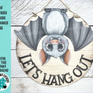 May include: A round wooden door hanger featuring a cartoon bat with large eyes and gray wings. The text "LET'S HANG OUT" is displayed below the bat. The words "BAT HALLOWEEN HANGING DOOR HANGER FILE" are printed on the left side.