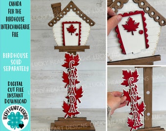 May include: A white birdhouse with a red maple leaf on the door, a wooden base, and a stack of red maple leaves with the word "CANADA" spelled out in white letters.