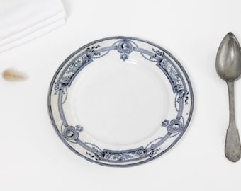 Antique French stained ironstone lunch or salad plate with deep blue transfer decor of birds, bows, garlands and medaillons