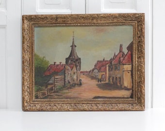 Vintage Dutch framed oil painting on canvas of village scene with church, rural landscape water and boats, brick red tones
