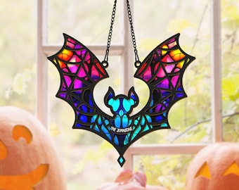 May include: A stained glass bat hanging in a window with a rainbow color scheme. The bat has a black outline and the text "The Johnsons" is written on the bat's body.