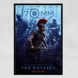 May include: A movie poster for The Odyssey, a film by Christopher Nolan, featuring a central figure in Roman-style armor with a red-crested helmet holding a sword, surrounded by armored soldiers in a blue-toned, misty forest setting with 70MM text.