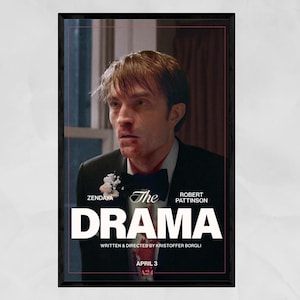 May include: A framed movie poster for "The Drama" featuring Robert Pattinson. The poster has a dark border and a distressed image of a man in a suit. The title is in large white letters, with the names of Zendaya and Kristoffer Borgli also visible.