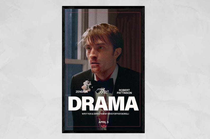 May include: A framed movie poster for "The Drama" featuring Robert Pattinson. The poster has a dark border and a distressed image of a man in a suit. The title is in large white letters, with the names of Zendaya and Kristoffer Borgli also visible.