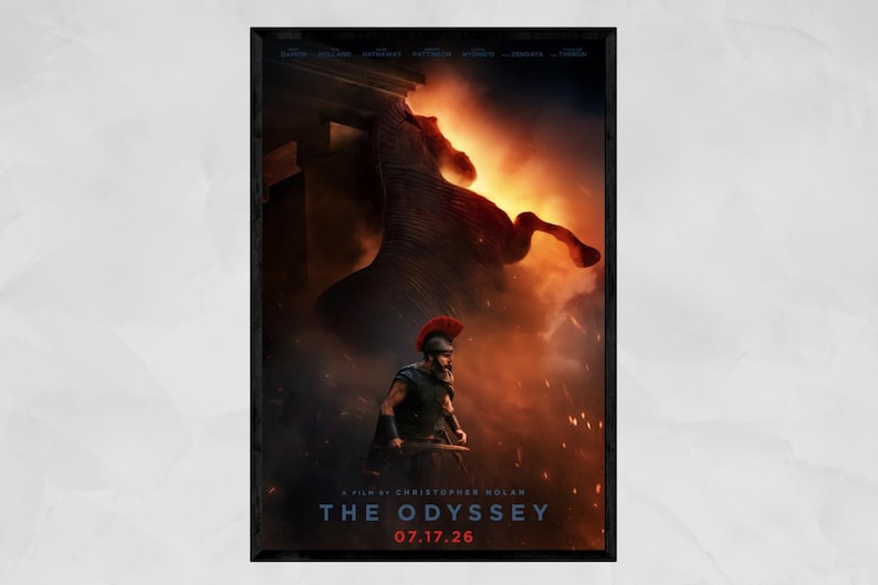 May include: A movie poster for The Odyssey, a film by Christopher Nolan, dated 07.17.26. The image features a warrior in a red-crested helmet and dark armor standing before a massive, dark horse silhouette emerging from golden fire and smoke.