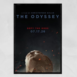 May include: A movie poster titled The Odyssey, a film by Christopher Nolan. The dark background features a stone sculpture of a face looking upward, surrounded by floating embers. Text reads: Defy the Gods, 07.17.26, and studio logos.