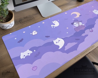 May include: A purple desk mat with a Halloween theme featuring cartoon cats, ghosts, bats, and a witch cat. The mat has a cloudy background with stars and a crescent moon. The text "DeskNeko" and website address are visible.