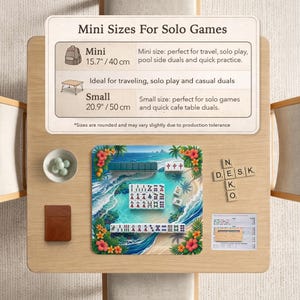 May include: A tabletop scene featuring a miniature Mahjong set with a tropical beach design. The set includes tiles, a brown leather-bound scorebook, and a small bowl with green stones. Text on the table reads "Mini Sizes For Solo Games."