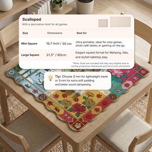 May include: A scalloped square tabletop mat with a colorful floral and geometric design. The mat is available in two sizes: 19.7 inches and 31.5 inches. The mat is suitable for games and tabletop play.