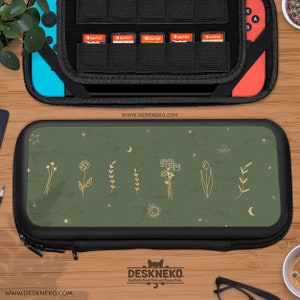 May include: A black and green Nintendo Switch carry case with a floral design. The case has a zip closure and the text "WWW.DESKNEKO.COM". The case is next to a Nintendo Switch console and a black case with game cartridges.