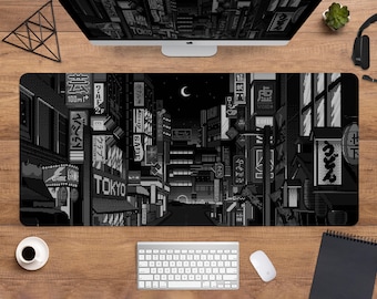 May include: Black and white pixel art mousepad featuring a nighttime cityscape with Japanese signage. The design includes the word "TOKYO" and various building details, creating a retro aesthetic. A computer keyboard and mouse are visible.