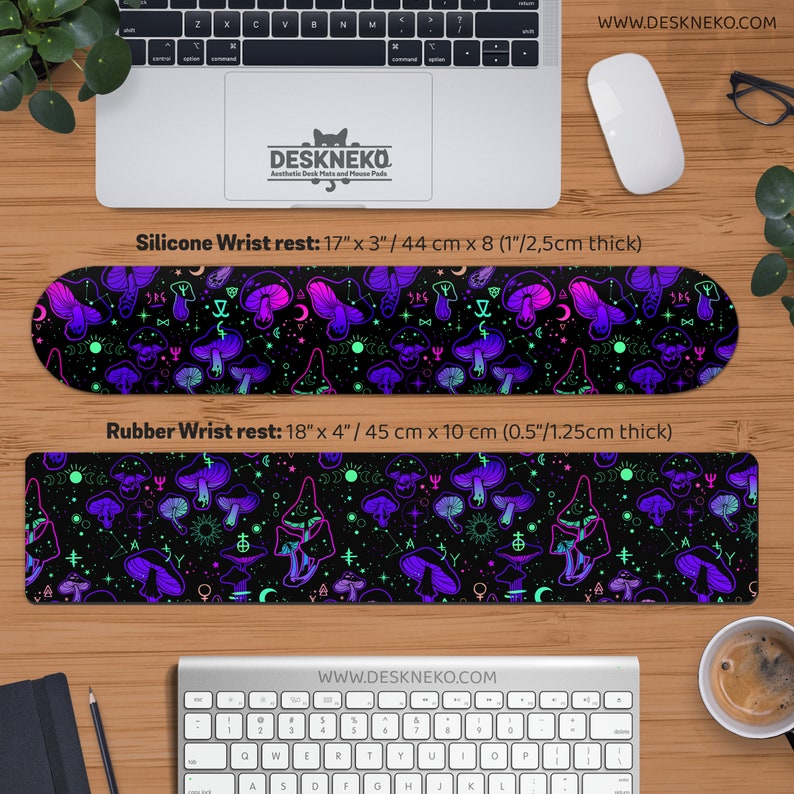 May include: Two wrist rests with a black background and a pattern of purple, pink, and green mushrooms and celestial symbols. The silicone wrist rest is 17 inches long, 3 inches wide, and 1 inch thick. The rubber wrist rest is 18 inches long, 4 inches wide, and 0.5 inches thick.