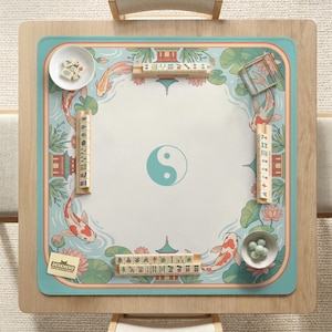 May include: A square mahjong table with a light blue border and a central design featuring a turquoise yin-yang symbol. The table mat has a koi fish and lotus flower design. Includes mahjong tiles and small bowls.