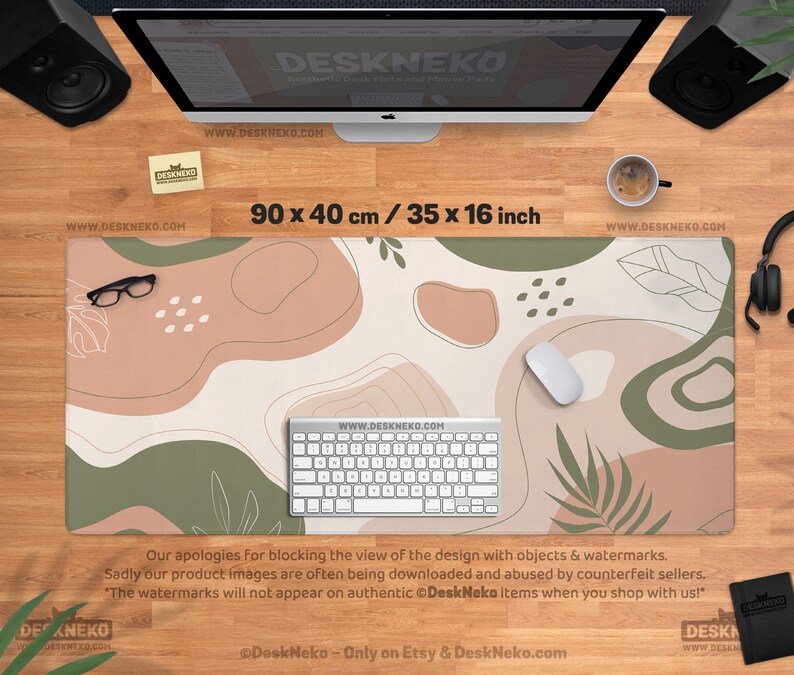 Puede incluir: Alfombrilla de escritorio con dise&ntilde;o abstracto en beige, verde y marr&oacute;n, mide 90 x 40 cm. La alfombrilla tiene un teclado, un rat&oacute;n y gafas. El texto "DeskNeko" y direcciones web son visibles.