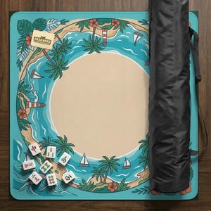 May include: A turquoise and beige mahjong mat with a tropical island design, featuring palm trees, sailboats, and a lighthouse. The mat has a large central beige circle and a black carrying case.