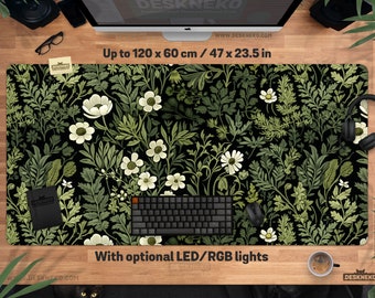 May include: A black desk mat with a floral design of white flowers and green leaves. The mat is up to 120 x 60 cm (47 x 23.5 in) in size and features the text "Up to 120 x 60 cm / 47 x 23.5 in" and "With optional LED/RGB lights".