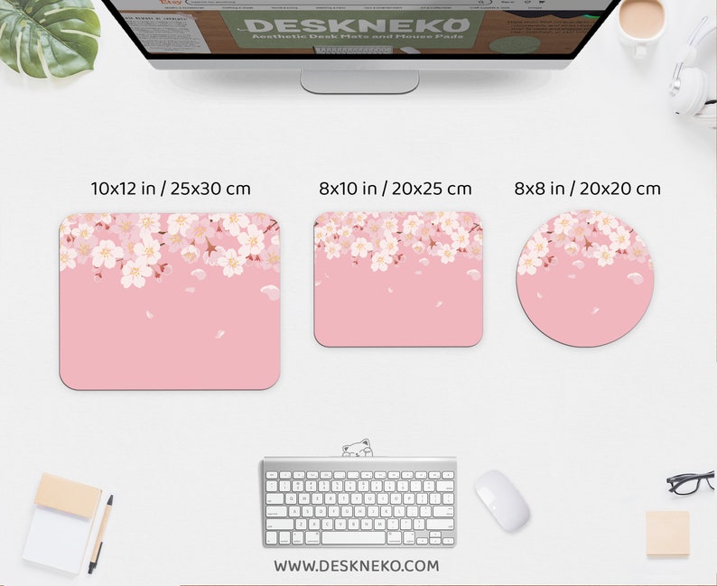 May include: Pink desk mats and mouse pads with a cherry blossom design. The rectangular mats are 10x12 inches and 8x10 inches, and the round mouse pad is 8x8 inches. The website address www.deskneko.com is visible.