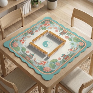May include: A square table with a decorative mat featuring a koi pond design. The mat has a scalloped edge and a light blue border. The koi pond design includes koi fish, lotus flowers, and pagodas. Wooden game pieces are arranged on the mat.