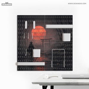 May include: A black pegboard with a Japanese-inspired landscape design, featuring a red sun and a figure in a traditional hat. Includes white shelves, hooks, and a cup. The text "DESKNEKO" and "WWW.DESKNEKO.COM" are visible.