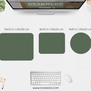 May include: Three green desk pads in different shapes and sizes: a 10x12 inch rectangle, an 8x10 inch rectangle, and an 8x8 inch circle. The pads are displayed with a keyboard, mouse, and a computer monitor. The website address is www.DESKNEKO.COM.