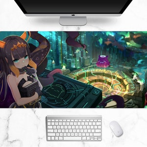 May include: A long rectangular mousepad featuring a colorful anime-style illustration. The artwork depicts a female character with black and yellow hair, holding a book, set in a fantasy environment with a circular design and a purple creature.