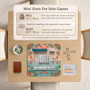 May include: A square mahjong mat with a pink flamingo and tropical flower pattern, featuring a central grid and rows of white tiles. Above, a sign reads Mini Sizes For Solo Games, listing 15.7 inches and 20.9 inches, with a small bowl and wooden tiles.