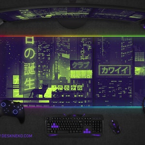 May include: A large rectangular gaming mouse pad with a neon cityscape design in purple and green. The pad features a black cat silhouette and Japanese text. A controller, keyboard, mouse, and headset surround the pad. The website address www.deskneko.com is printed at the bottom.