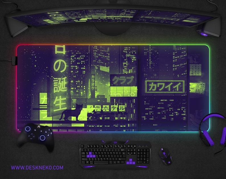 May include: A large rectangular gaming mouse pad with a neon cityscape design in purple and green. The pad features a black cat silhouette and Japanese text. A controller, keyboard, mouse, and headset surround the pad. The website address www.deskneko.com is printed at the bottom.