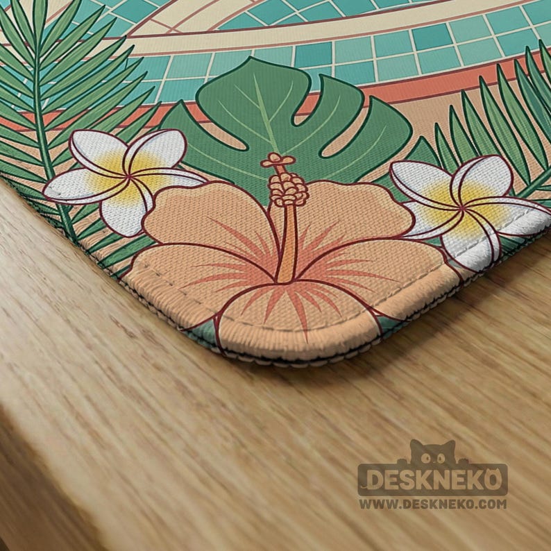 May include: A rectangular desk mat featuring a tropical floral design. The mat showcases a large orange hibiscus flower, white plumeria flowers, and green leaves. The background includes a pool design with teal tiles and a beige border. The Deskneko logo is visible.