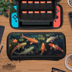 May include: Black zippered case with a koi pond design, holding a Nintendo Switch console and game cartridges. The case features a vibrant illustration of orange, white, and green koi fish swimming in a pond with lily pads. The text "DESKNEKO" and "www.DESKNEKO.com" are visible.