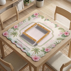 May include: A square mahjong mat with a scalloped edge featuring a tropical print of pink hibiscus flowers and palm trees. The center has a light pink striped square with four wooden mahjong tile racks arranged in a square formation.