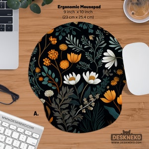 May include: Ergonomic mousepad with a floral design. The mousepad is 9 inches x 10 inches and features a black background with orange, white, and green flowers. The mousepad has a wrist rest for added comfort.