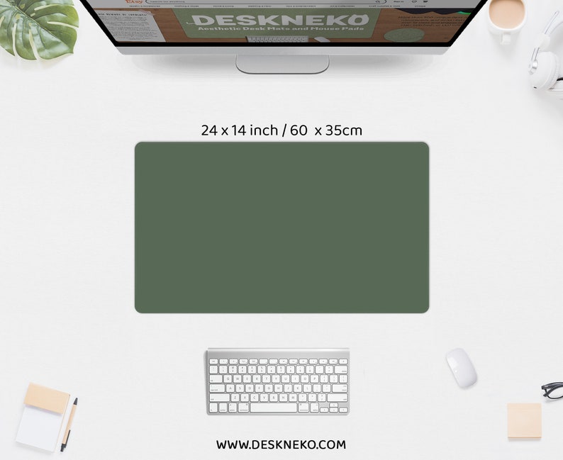 May include: A dark green rectangular desk mat, 24 x 14 inches, sits on a white desk. A computer keyboard, mouse, and monitor are also visible. The monitor displays the text "DESKNEKO Aesthetic Desk Mats and Mouse Pads". The website address www.deskneko.com is at the bottom.