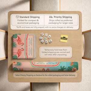 May include: A Mahjong mat featuring a pink flamingo and tropical leaf pattern, displayed both folded and rolled. The mat includes printed text for game instructions, accompanied by several white Mahjong tiles and a yellow square note with the text DESKNEKO.