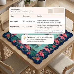 May include: A scalloped square tabletop mat with a flamingo and tropical leaf design. The mat is dark blue with a scalloped edge and features pink flamingos and green leaves. The mini square is 19.7 inches and the large square is 31.5 inches.