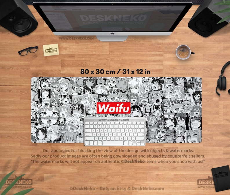 May include: A black and white desk mat featuring a collage of anime-style faces. The mat has the word "Waifu" in red and white. The mat measures 31 x 12 inches.