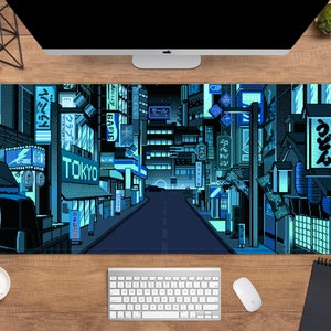 May include: A rectangular desk mat with a pixelated illustration of a Tokyo street scene at night. The design is predominantly blue with neon signs and buildings. The word "TOKYO" is prominently displayed.