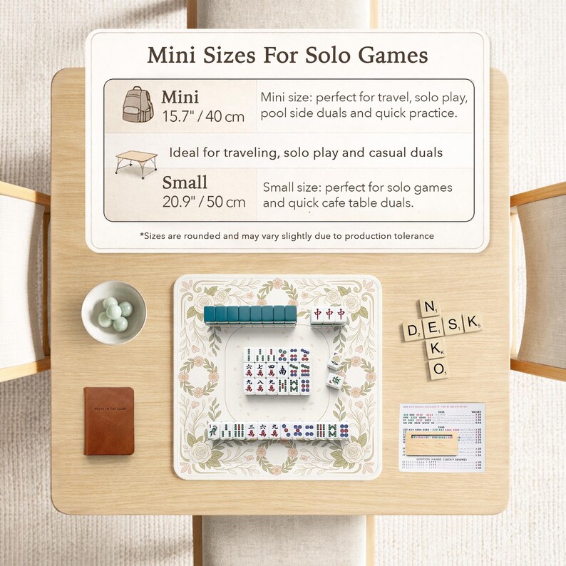 May include: A Mahjong set with teal and white tiles on a floral patterned mat. Includes a bowl of green markers, a brown notebook, and wooden letter tiles spelling N, E, D, S, K, O. A sign displays Mini 15.7 inches and Small 20.9 inches sizes.
