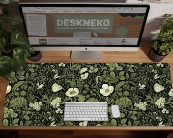 May include: Desk mat with a floral design in green and white on a black backdrop. A keyboard, mouse, and computer monitor displaying the Etsy website are on the mat. The brand name "DESKNEKO" is visible. The mat is designed for aesthetic use.