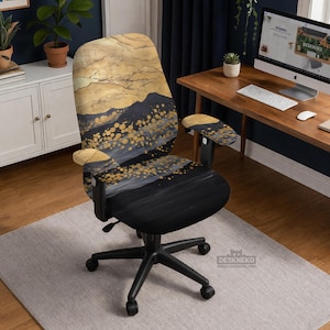 May include: An office chair with a black base and a patterned back and seat. The design features a gold and black abstract landscape with mountain and dot details. The armrests also have the same gold and black pattern.