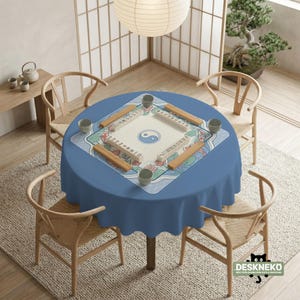 May include: A circular blue table set for Mahjong, with four wooden chairs around it. The table has a Mahjong mat with a Yin Yang symbol and floral designs. A paper lantern hangs above, with a bonsai tree and tea set in the background.