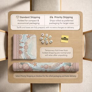 May include: A rolled-up desk mat and a folded desk mat with a beach-themed design featuring seashells, starfish, and coral in shades of pink, blue, and beige. The image also shows Mahjong tiles and text about shipping options.