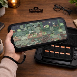May include: Black Nintendo Switch carrying case with a whimsical illustration of frogs in a greenhouse. The case has a zipper closure and a wrist strap. The brand name "DESKNEKO" is printed on the top of the case.