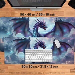 May include: Two rectangular desk mats with a fantasy dragon design. The larger mat measures 35 x 16 inches, and the smaller one is 31.5 x 12 inches. The dragon is purple, blue, and red, set against a cloudy sky background.