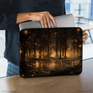 May include: A black laptop sleeve featuring a digital art print of a mystical forest scene. The design showcases a dark forest with glowing lights, trees, and a reflective water surface. The sleeve has a zipper closure and the text "DESKNEKO" is visible.