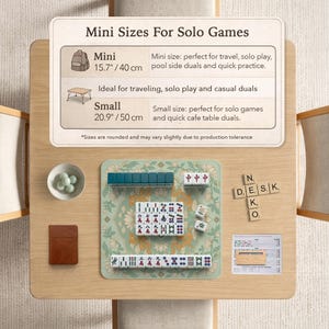 May include: A mini Mahjong set on a wooden table. The set includes tiles, dice, and a green mat with a floral design. The table also has a small bowl with green spheres and a brown notebook. The text on the sign says "Mini Sizes For Solo Games".